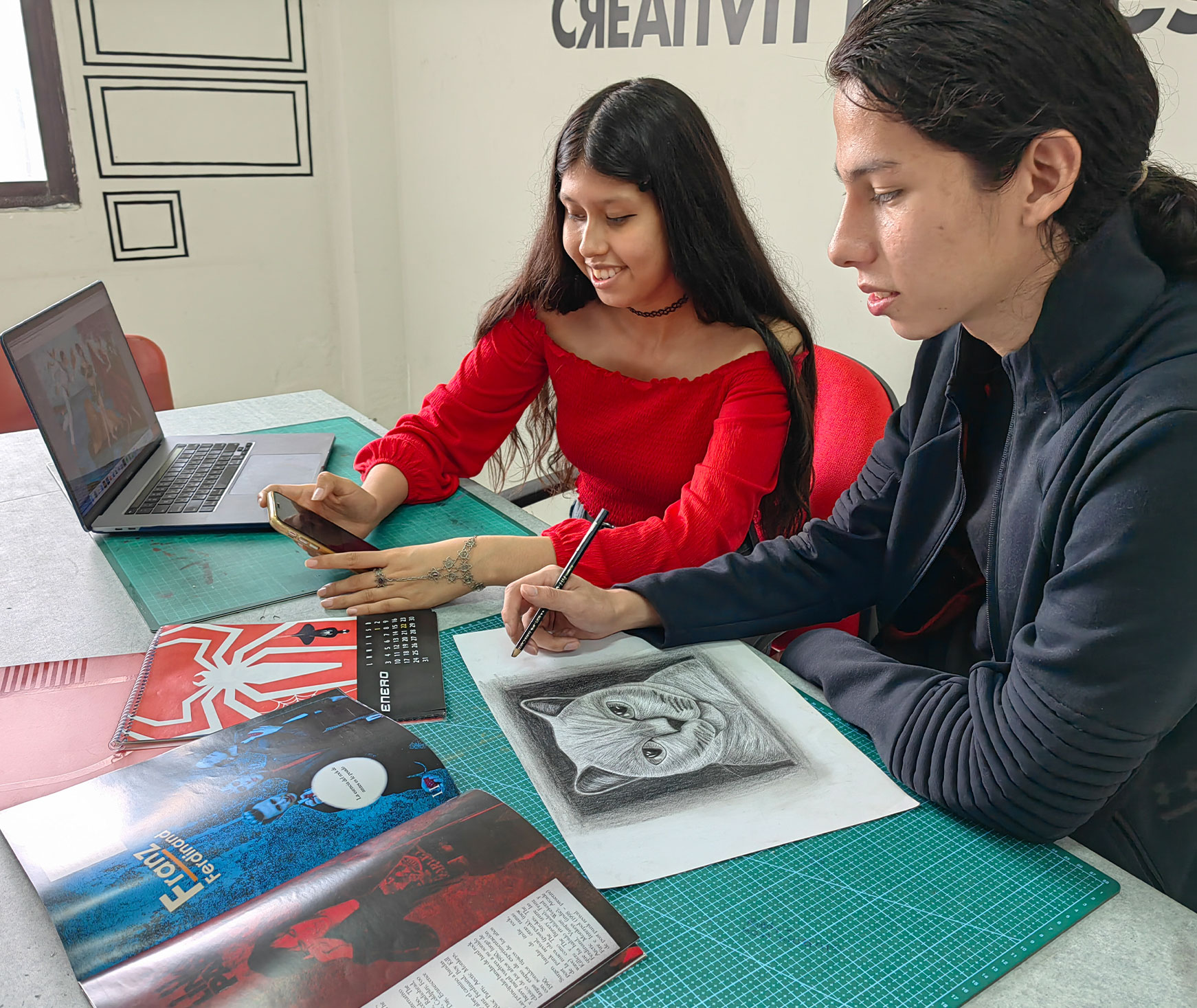 Estudiantes de diseño grafico realizando diseños